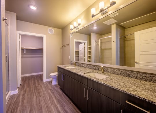 Harmony Luxury Apartments large bathroom with wooden floors