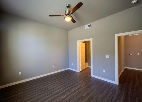 Harmony Luxury Apartments large bedroom with ceiling fan and tall ceilings