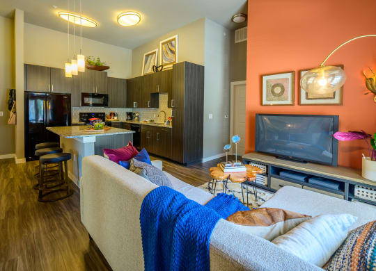 Harmony Luxury Apartments entertainment room with hardwood floors