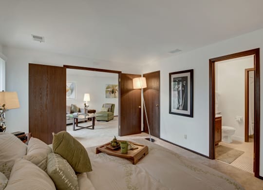 a bedroom with a bed and a floor lamp