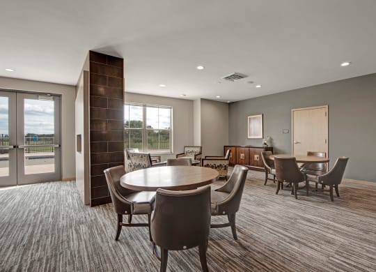 The Clubhouse at The Vue at Pinnacle Peak Apartment Homes Apartments in Fitchburg, WIed with furniture and a large window