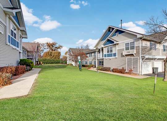 A residential area with houses and a green lawn.