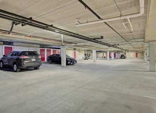 A spacious underground parking garage here at Van Buren Place with reserved parking spaces and individual storage units. A clean concrete floor and bright overhead lighting create a secure, convenient environment for residents.