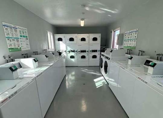 A laundromat with rows of washers and dryers.