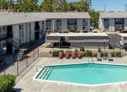 A swimming pool in front of apartment buildings.