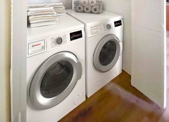 A small laundry room with a washer and dryer.