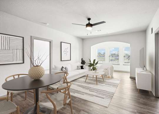 an open living room and dining room with a ceiling fan