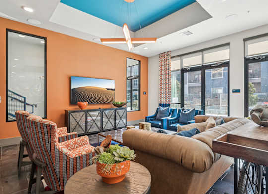 A living room with orange walls and furniture.