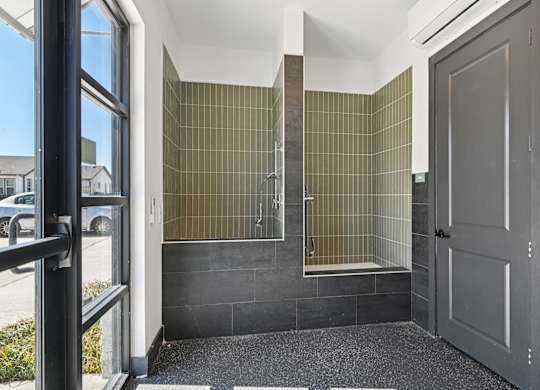 A bathroom with a shower and a toilet.