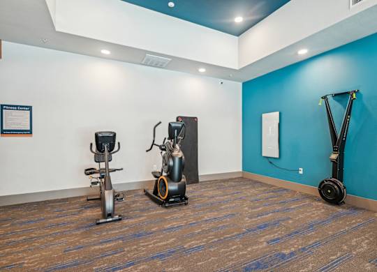 A gym with a blue wall and a wooden floor.