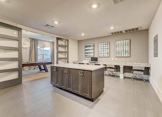 A spacious kitchen with a marble countertop and a large island.