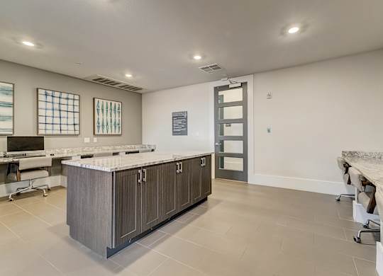 A kitchen with a marble countertop and a long island.
