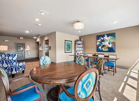 A room with a wooden table surrounded by chairs.