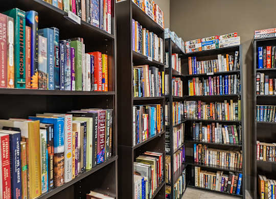 A bookshelf filled with a variety of colorful books.