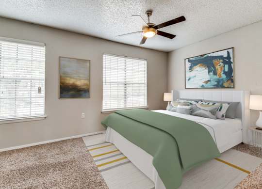 A bedroom with a bed, two lamps, and two pictures on the wall.