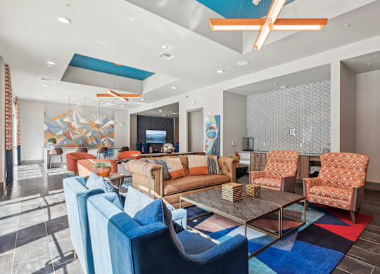 A living room with a glass table and blue chairs.