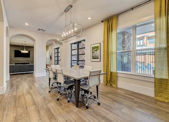 A conference room with a long table and chairs.