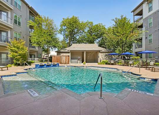 A swimming pool surrounded by apartment buildings.