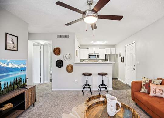 A living room with a brown couch and a wooden coffee table.