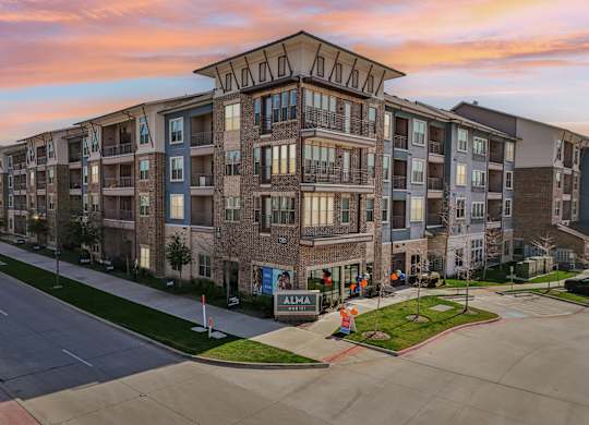 Apartment complex with a sign that says "ALMA".