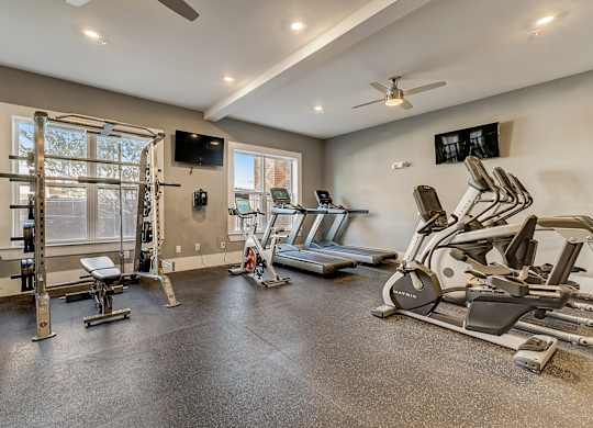 A spacious home gym with a variety of exercise equipment.