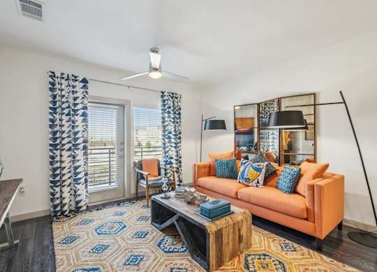 A living room with a sofa, a coffee table, and a rug.