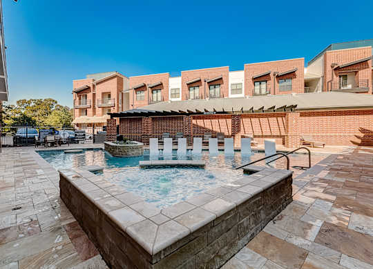 A pool with a hot tub in the middle of it.