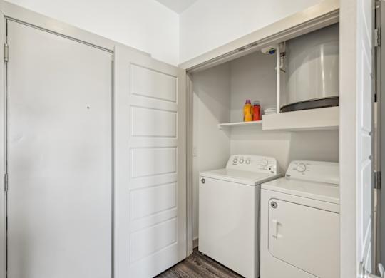 A white laundry room with a washer and dryer.