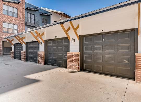 A row of garage doors in front of a building.