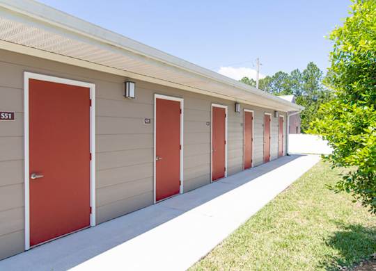 A series of garage doors are lined up on a building.