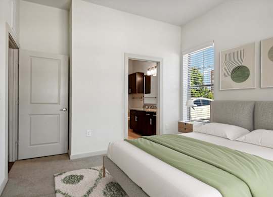 a bedroom with a bed and a door to a bathroom