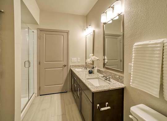 A bathroom with a sink, mirror, and toilet.
