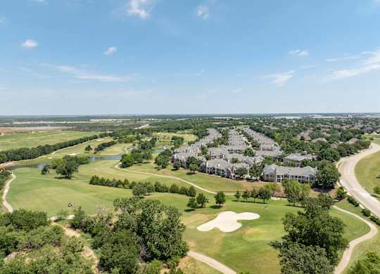 Aerial view of Townhomes of Coyote Ridge beside fairways, trees, and walking paths.