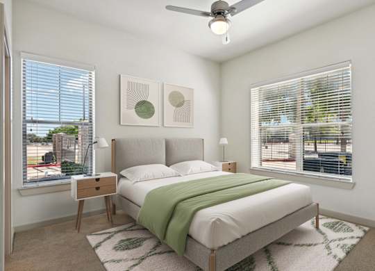 a bedroom with a bed and two windows