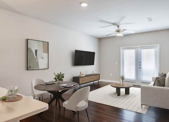A modern living room with a dining table and chairs.
