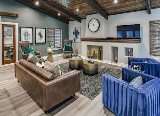 Inviting community lounge with fireplace feature wall, TV nook, and modern seating.