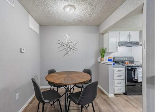 A dining area with a wooden table and chairs.