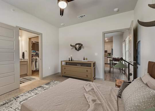 a bedroom with a bed and a dresser and a closet