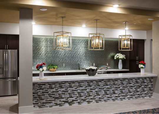 a kitchen with a counter and a stainless steel refrigerator