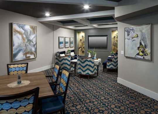 a dining room with tables and chairs and paintings