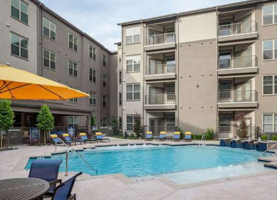 a swimming pool in front of an apartment building