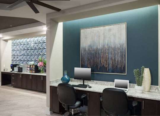 a large office with two desks and two computers