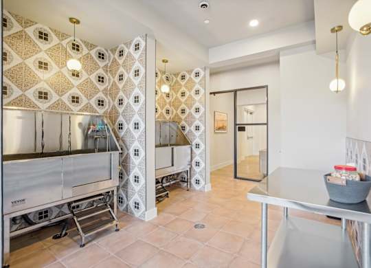 a kitchen with stainless steel appliances and a tiled wall