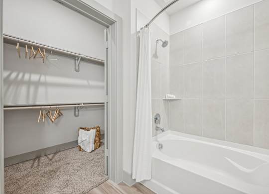 a bathroom with a shower and a tub and a shower curtain
