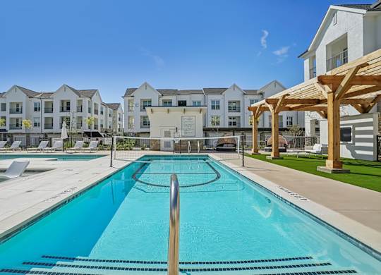 a swimming pool with apartment buildings in the background