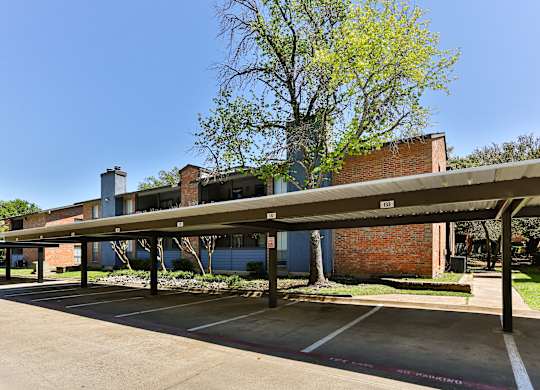 A parking lot with a building in the background.