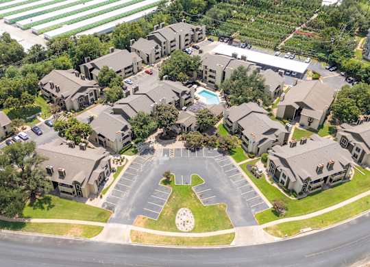 A bird's eye view of a residential area with houses and a roundabout.