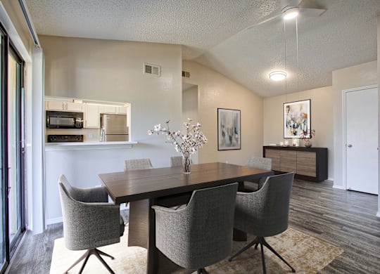 A dining room with a table and chairs.
