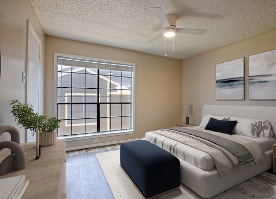 A bedroom with a large bed and a window with a view of a building.