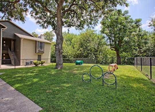 A house with a green lawn and a tree.